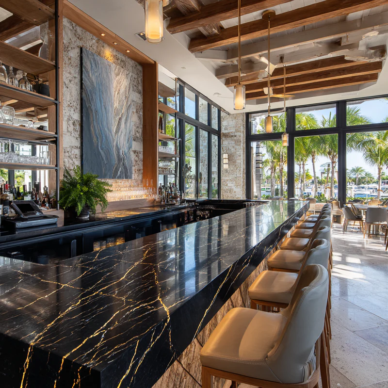 Stylish bar area with quartz backsplash, integrated wine refrigerator, and wood cabinetry